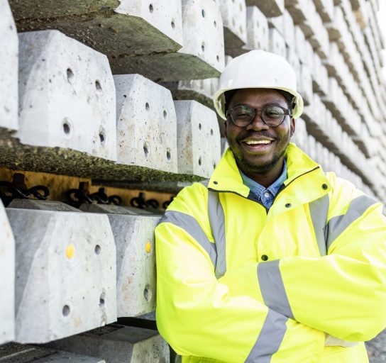 Portrait of construction worker standing by railroad ties.